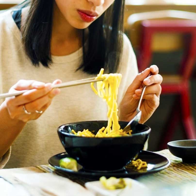 An attractive woman eating at a restaurant.