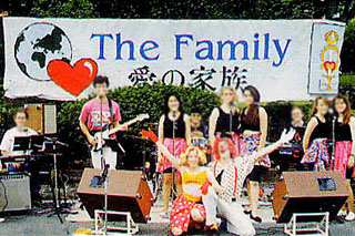 A picture of a group of people who look like they might be performing music at a park or something.