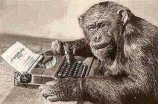 A monkey typing at a computer.